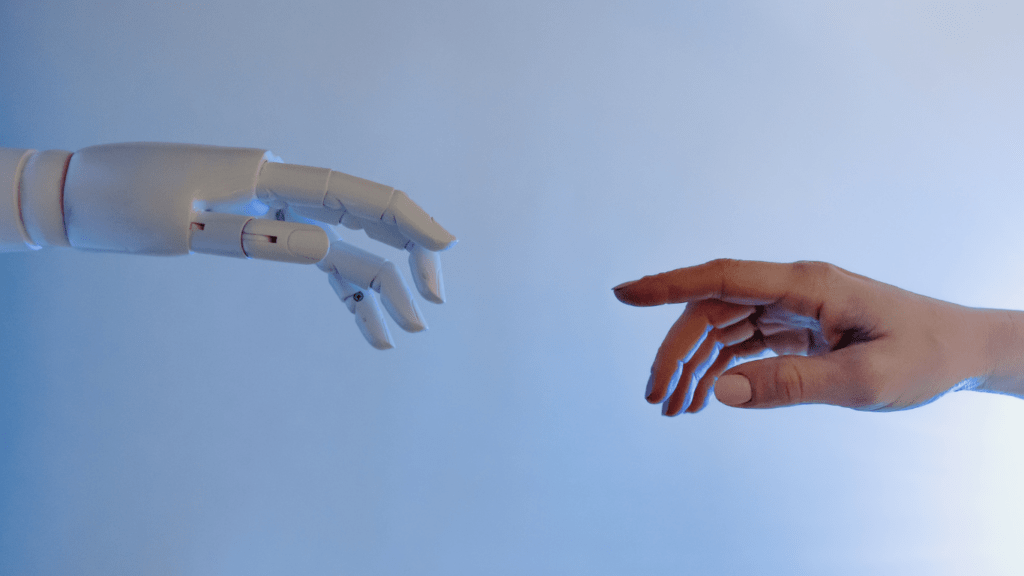 a hand of a human and an ai robot