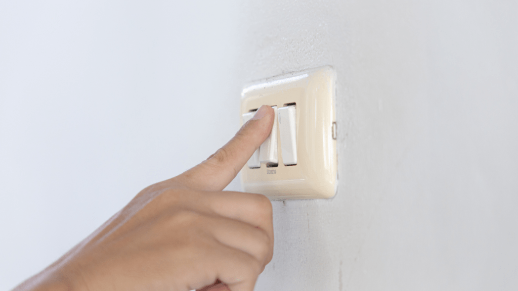 a man pointing to a switch