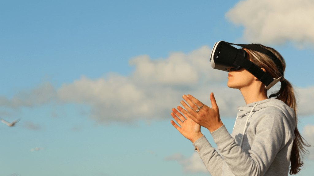 a woman using vr goggles outside 